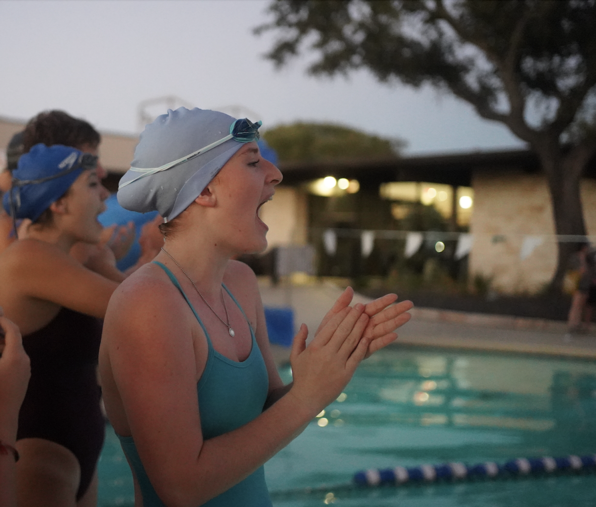 FIRST SEASON SPLASH: Senior Captain Mallory Beckham and other swim teammates cheer on swimmers in the 50 freestyle last night at Great Hills Country Club pool. The meet took place at their home pool where they practice every night. It marked the beginning of the McCallum swim season, and gave a chance for new swimmers to get official times to use in events at future competitions. Although the team did not compete with other schools at this meet, Beckham thinks that it was helpful to have in the long run. 

“We got to cheer and support everyone through their first meet of the year and it helped to give the new swimmer a chance to experience a meet environment before we go to the more serious meets,” Beckham said. “Everyone was so supportive and happy for eachother with congratulating and cheering. And a lot of people dropped time too.” 

According to Beckham, this will be a good season for the team because of the amount of support from everyone at the last meet. 

“Everyone is being so supportive of each other and everyone is going to make great progress with dropping times,” Beckham said. “This is going to be a great season for everyone to drop time.” 